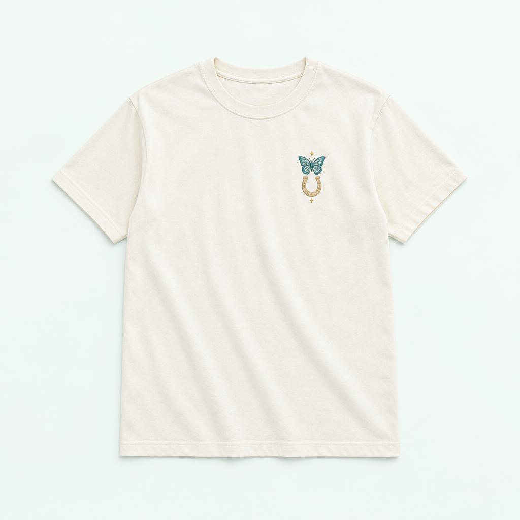 Ivory tee with butterfly and horseshoe design